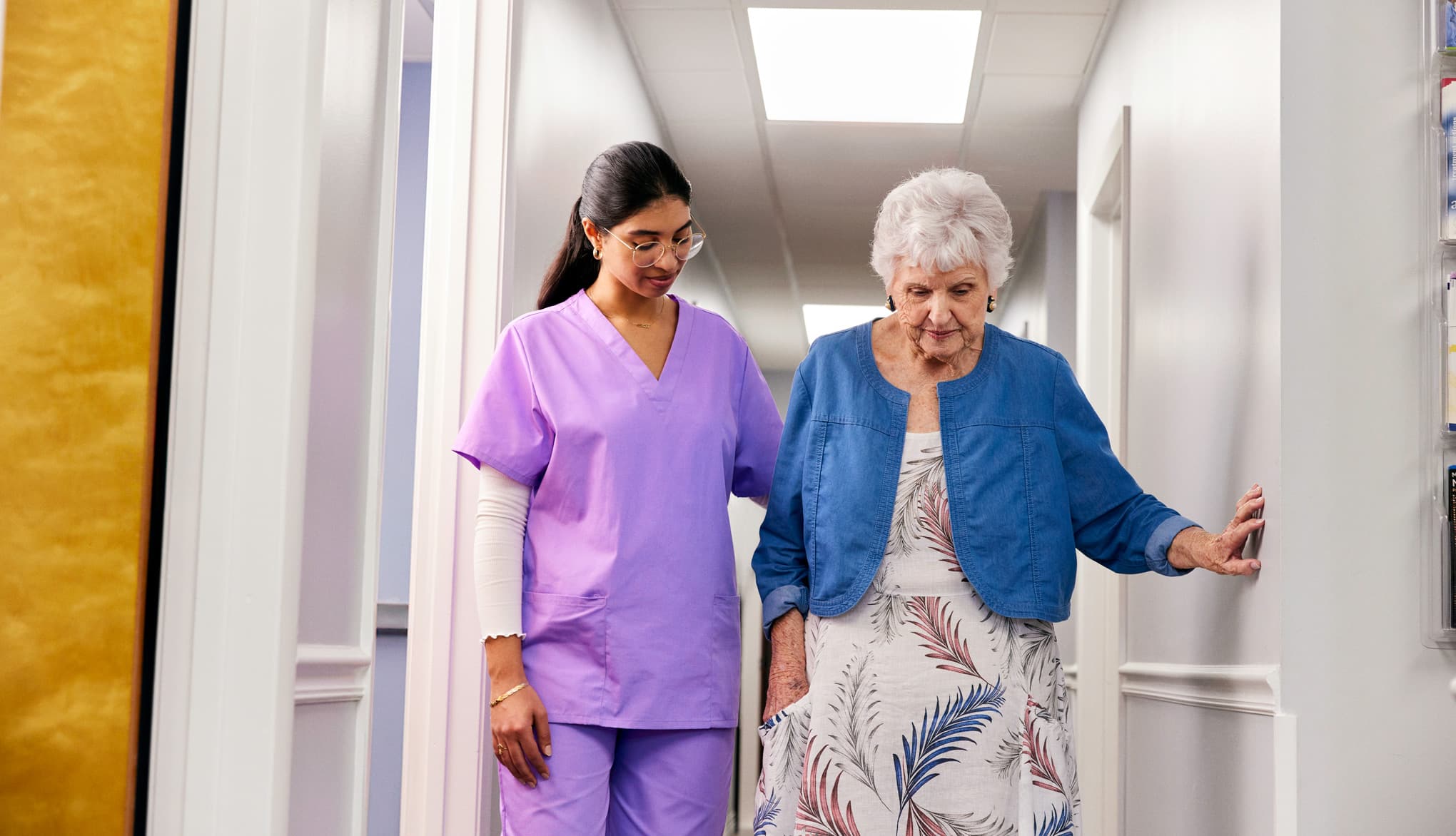 Elderly woman with a caregiver